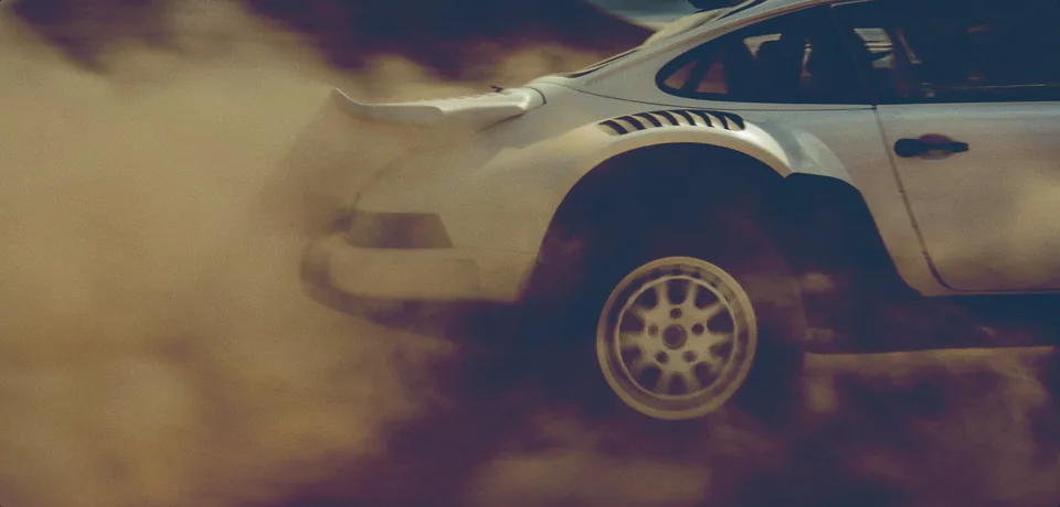 A Porsche kicking up dust in the desert