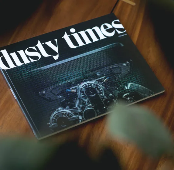 Dusty Times cover photographed on a wooden table