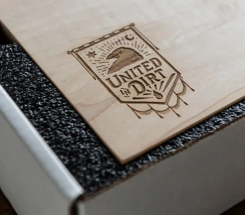 United in Dirt mark engraved on the wooden Dusty Times presentation box